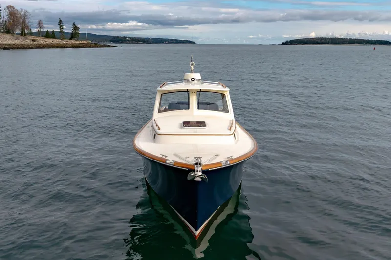 Lab Adore Yacht Photos Pics 2003 Hinckley Picnic Boat EP on calm waters, scenic coastal background.