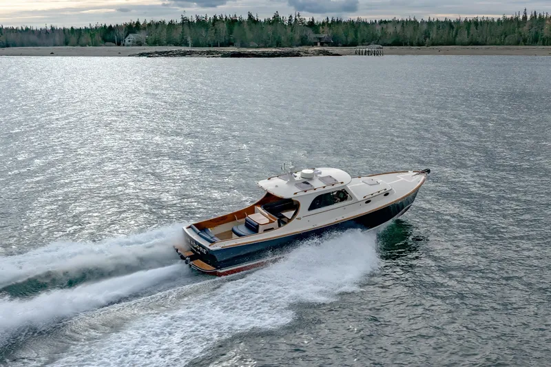 Lab Adore Yacht Photos Pics 2003 Hinckley Picnic Boat EP cruising on a scenic waterway.
