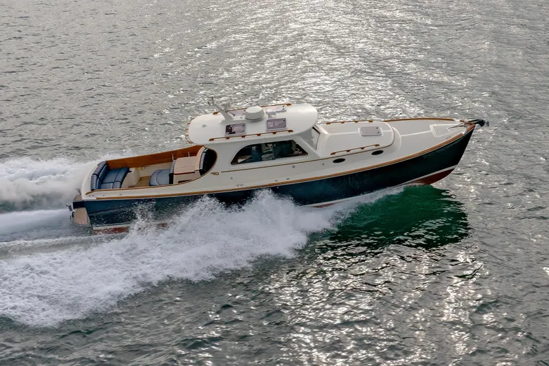 Lab Adore Yacht Photos Pics 2003 Hinckley Picnic Boat EP cruising on water, showcasing elegant design and performance.