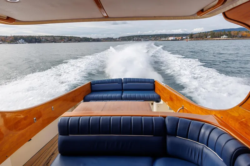Lab Adore Yacht Photos Pics 2003 Hinckley Picnic Boat EP cruising on open water, featuring elegant seating and wooden finishes.