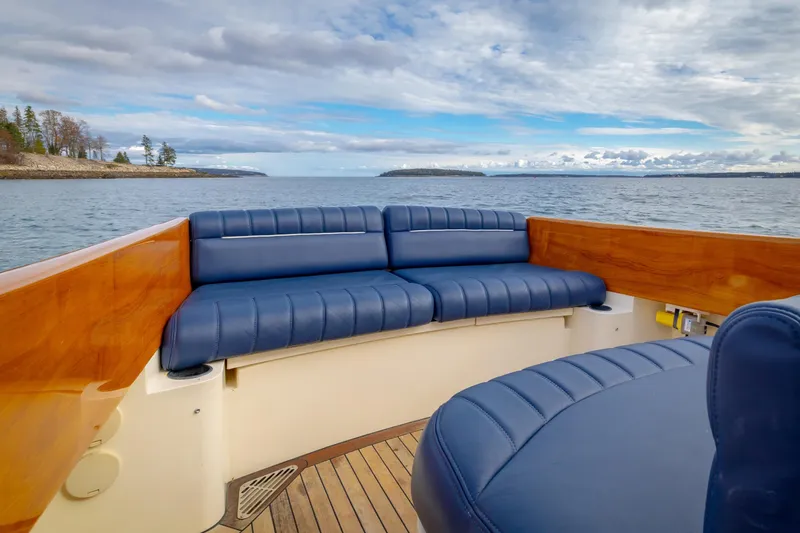 Lab Adore Yacht Photos Pics 2003 Hinckley Picnic Boat EP with blue seating, wooden accents, and scenic ocean view.