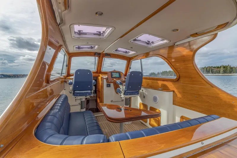 Lab Adore Yacht Photos Pics 2003 Hinckley Picnic Boat EP interior with elegant wood finish and blue seating.