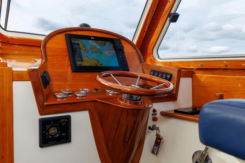 Lab Adore Yacht Photos Pics 2003 Hinckley Picnic Boat EP helm with wooden dashboard and navigation screen.