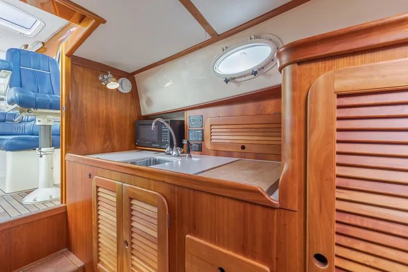 Lab Adore Yacht Photos Pics 2003 Hinckley Picnic Boat EP interior with wooden cabinetry and modern amenities.