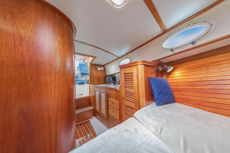 Lab Adore Yacht Photos Pics 2003 Hinckley Picnic Boat EP interior with wooden finish and cozy cabin space.