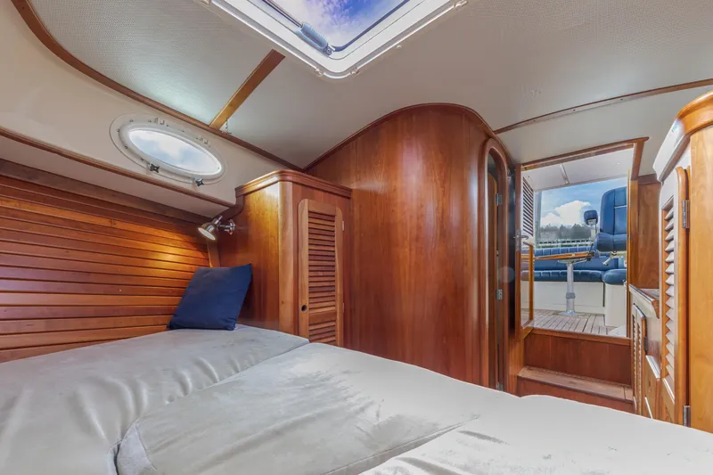 Lab Adore Yacht Photos Pics Interior of 2003 Hinckley Picnic Boat EP with wooden finishes and cozy sleeping area.