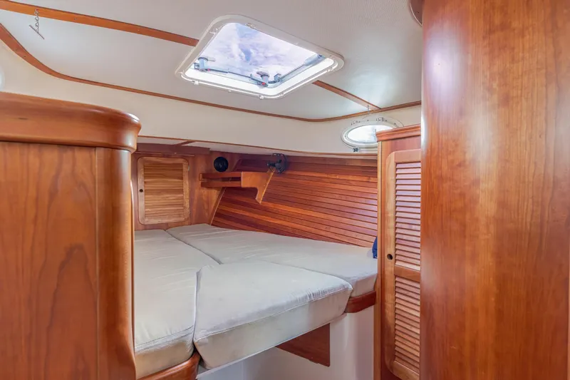 Lab Adore Yacht Photos Pics Interior of 2003 Hinckley Picnic Boat EP with wooden finish and cozy sleeping area.