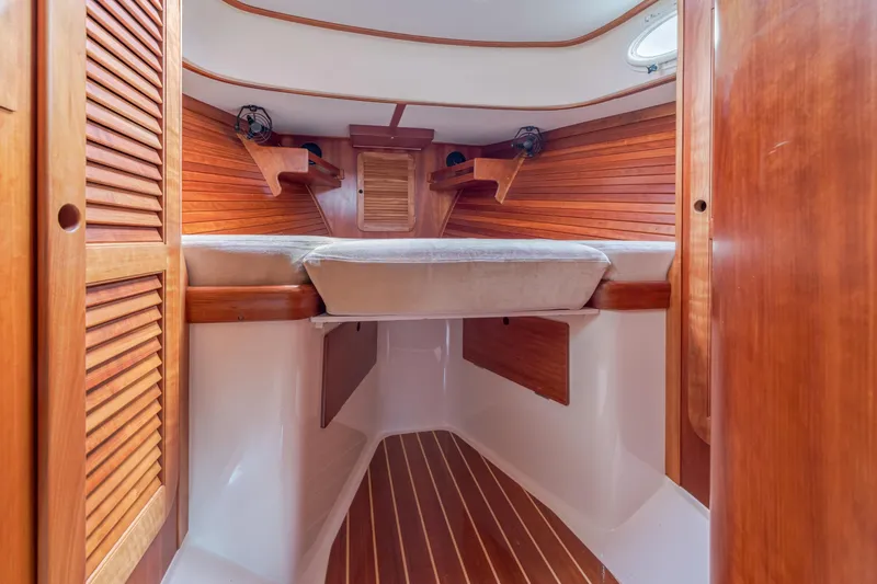 Lab Adore Yacht Photos Pics Interior of 2003 Hinckley Picnic Boat EP with wooden finishes and cozy sleeping area.