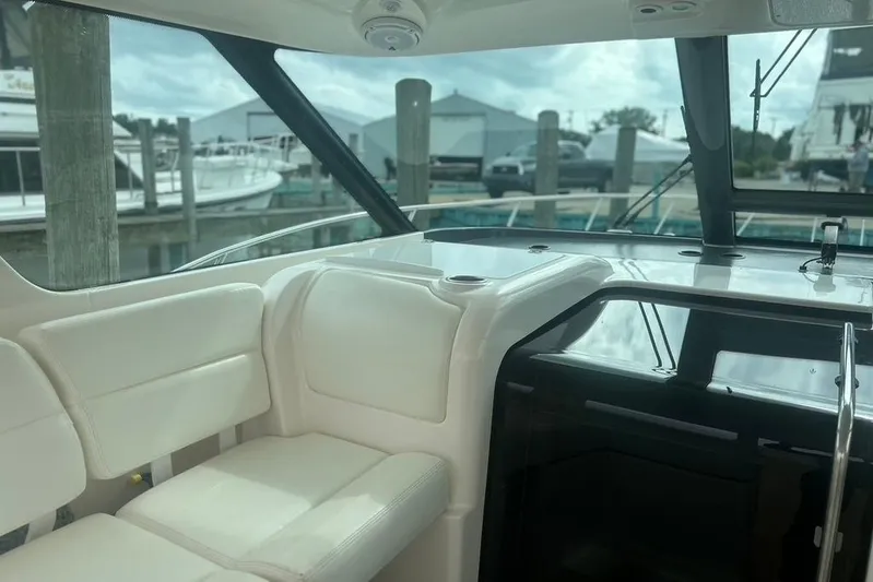  Yacht Photos Pics Interior view of 2005 Tiara Yachts 3600 Sovran, featuring white seating and marina backdrop.