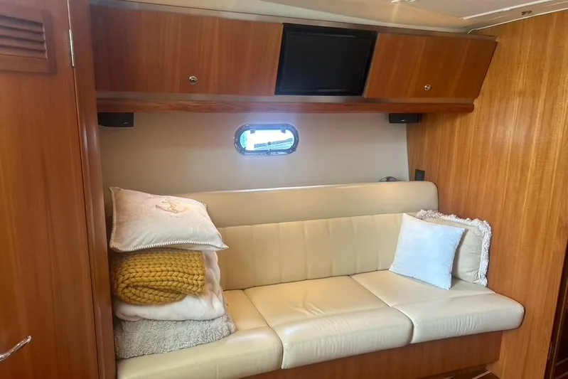  Yacht Photos Pics 2005 Tiara Yachts 3600 Sovran interior with beige leather sofa and wooden cabinetry.