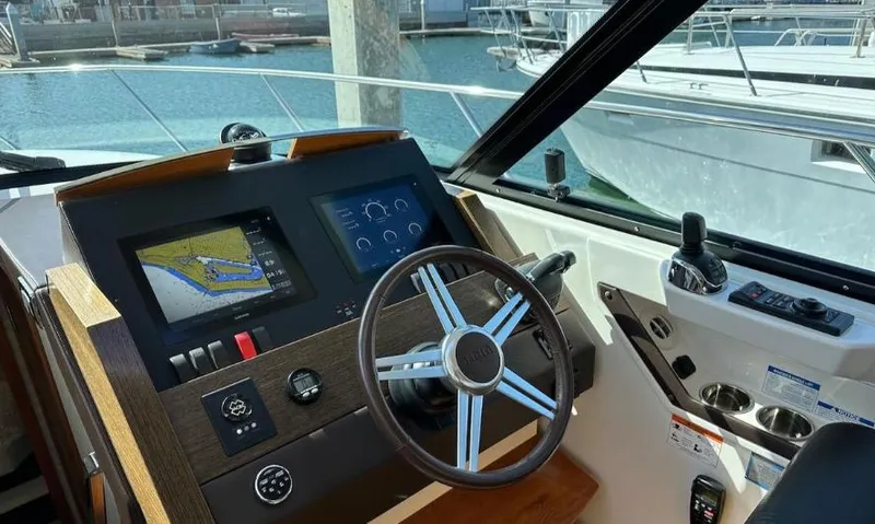  Yacht Photos Pics Helm of 2015 Tiara Yachts C44 Coupe with navigation screens and steering wheel.