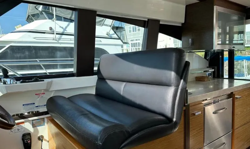  Yacht Photos Pics 2015 Tiara Yachts C44 Coupe interior with leather seating and modern kitchen amenities.