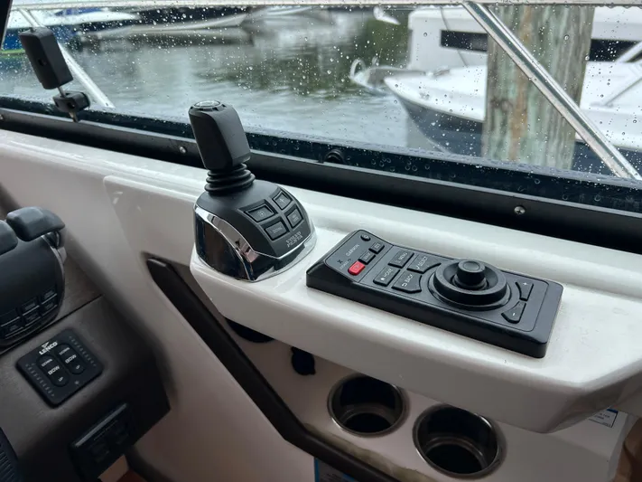  Yacht Photos Pics Control panel of a 2015 Tiara Yachts C44 Coupe with joystick and buttons.