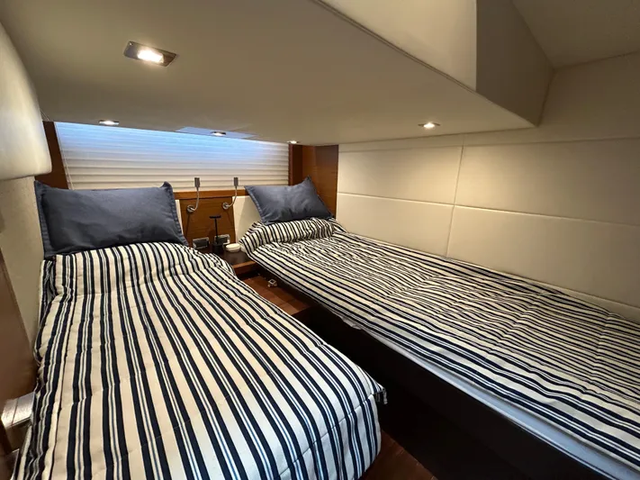  Yacht Photos Pics Twin beds in a 2015 Tiara Yachts C44 Coupe cabin with striped bedding.