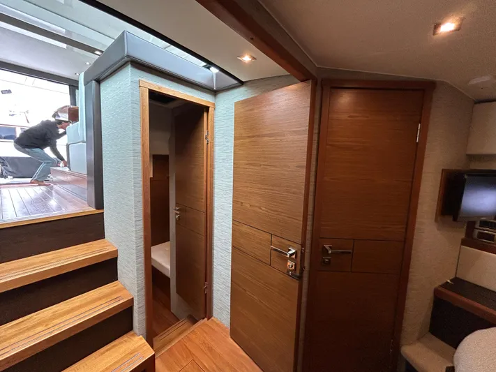 Yacht Photos Pics Interior of 2015 Tiara Yachts C44 Coupe, featuring wooden doors and stairs.