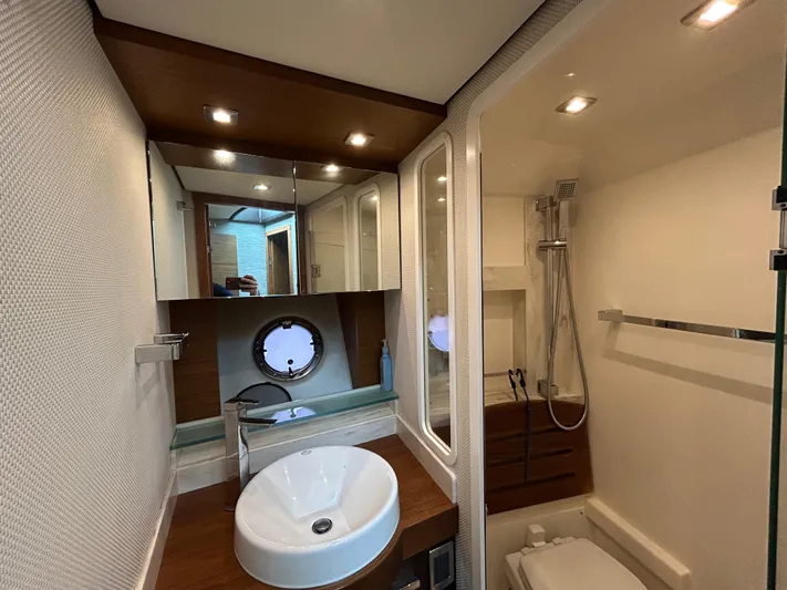  Yacht Photos Pics Luxurious bathroom in 2015 Tiara Yachts C44 Coupe with modern fixtures and elegant design.