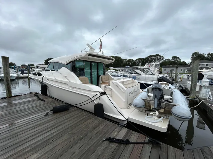  Yacht Photos Pics 2015 Tiara Yachts C44 Coupe docked at marina with inflatable boat.