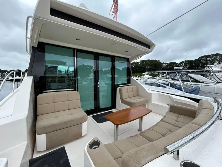  Yacht Photos Pics 2015 Tiara Yachts C44 Coupe with outdoor seating and table, docked at marina.