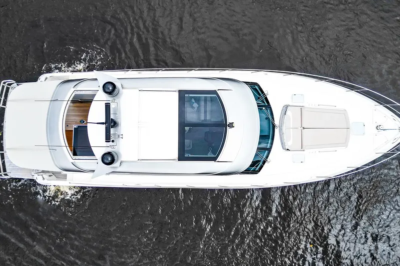 Frivolous Yacht Photos Pics Aerial view of 2021 Riviera 5400 Sport Yacht Platinum Edition cruising on water.