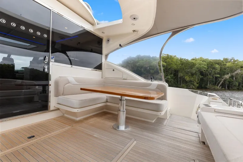 Frivolous Yacht Photos Pics Luxurious 2021 Riviera 5400 Sport Yacht Platinum Edition with elegant outdoor seating area.