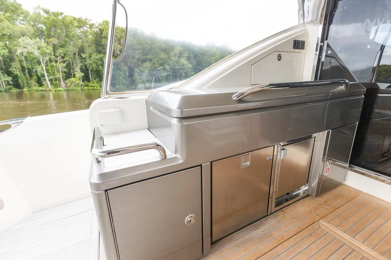 Frivolous Yacht Photos Pics 2021 Riviera 5400 Sport Yacht Platinum Edition outdoor kitchen area with sleek stainless steel design.