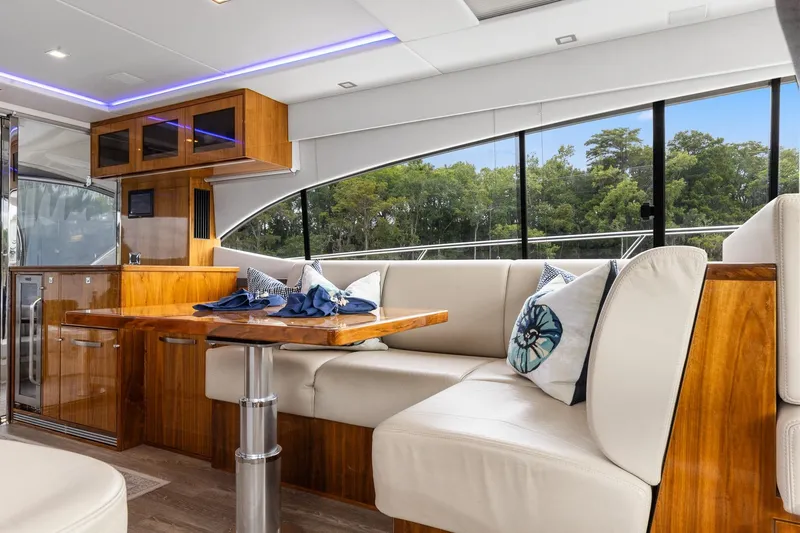 Frivolous Yacht Photos Pics Luxurious interior of 2021 Riviera 5400 Sport Yacht Platinum Edition with elegant seating and wood finishes.