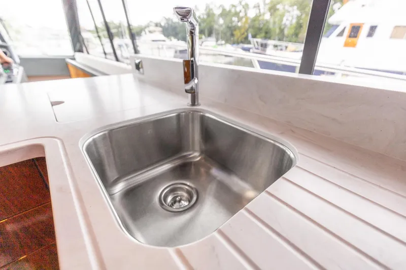 Frivolous Yacht Photos Pics Stainless steel sink on 2021 Riviera 5400 Sport Yacht Platinum Edition.