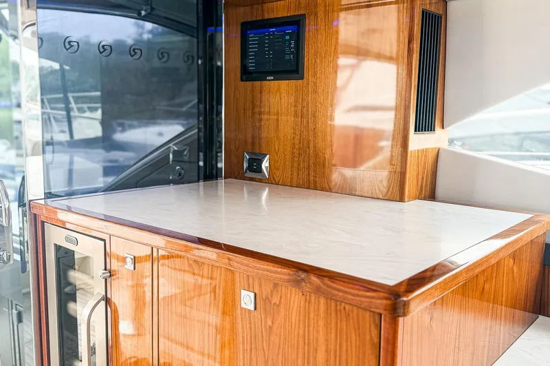 Frivolous Yacht Photos Pics Luxurious interior of 2021 Riviera 5400 Sport Yacht Platinum Edition with wood finish and modern amenities.