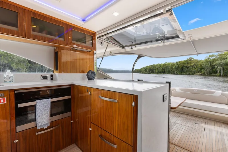 Frivolous Yacht Photos Pics Luxurious interior of 2021 Riviera 5400 Sport Yacht with scenic river view.