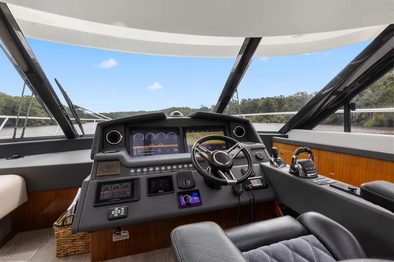 Frivolous Yacht Photos Pics Helm of 2021 Riviera 5400 Sport Yacht Platinum Edition with advanced navigation controls.