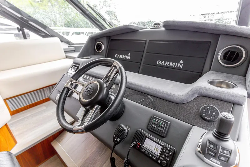 Frivolous Yacht Photos Pics 2021 Riviera 5400 Sport Yacht helm with Garmin navigation system and modern controls.