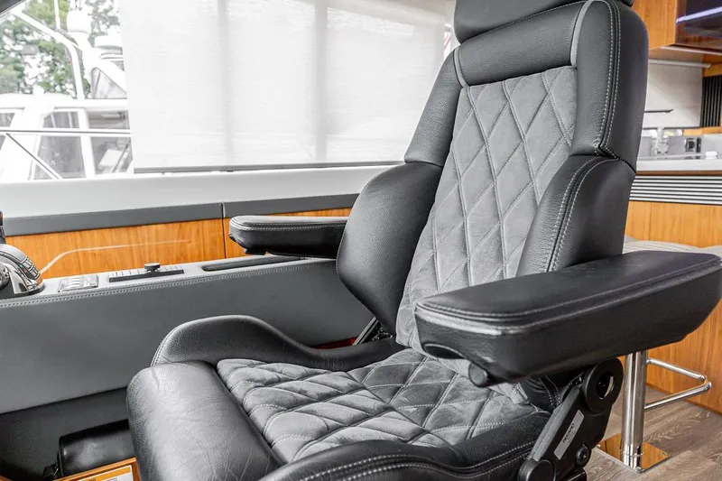 Frivolous Yacht Photos Pics Luxurious leather seat in 2021 Riviera 5400 Sport Yacht Platinum Edition cockpit.
