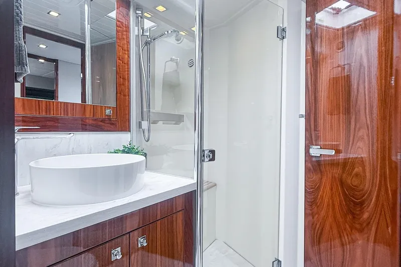 Frivolous Yacht Photos Pics Luxurious bathroom in 2021 Riviera 5400 Sport Yacht Platinum Edition with modern fixtures.