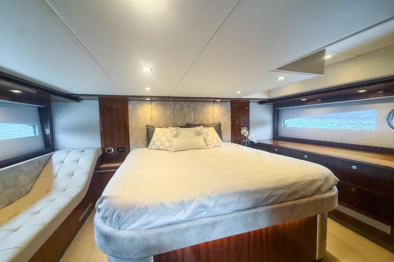 Frivolous Yacht Photos Pics Luxurious bedroom interior of 2021 Riviera 5400 Sport Yacht Platinum Edition with elegant furnishings.
