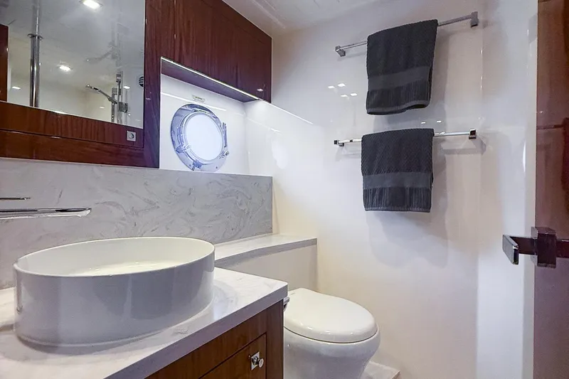 Frivolous Yacht Photos Pics Luxurious bathroom in 2021 Riviera 5400 Sport Yacht Platinum Edition with modern fixtures.