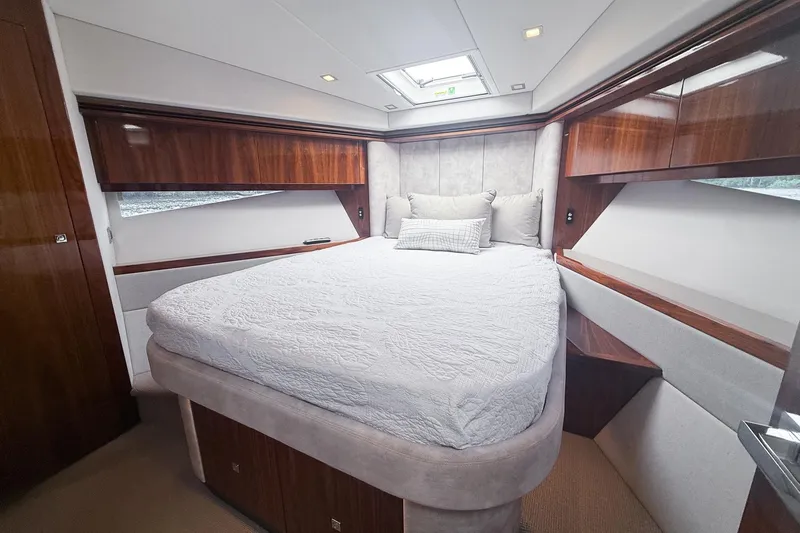 Frivolous Yacht Photos Pics Luxurious bedroom in 2021 Riviera 5400 Sport Yacht Platinum Edition with elegant wood finishes.