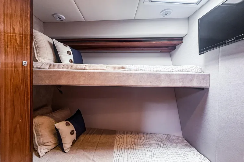 Frivolous Yacht Photos Pics Interior of 2021 Riviera 5400 Sport Yacht Platinum Edition with cozy bunk beds.