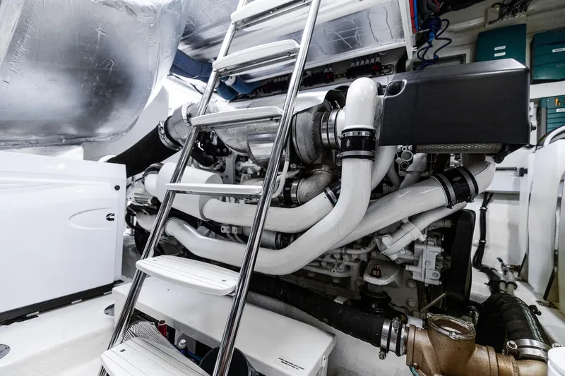 Frivolous Yacht Photos Pics Engine room of 2021 Riviera 5400 Sport Yacht Platinum Edition with ladder and machinery.