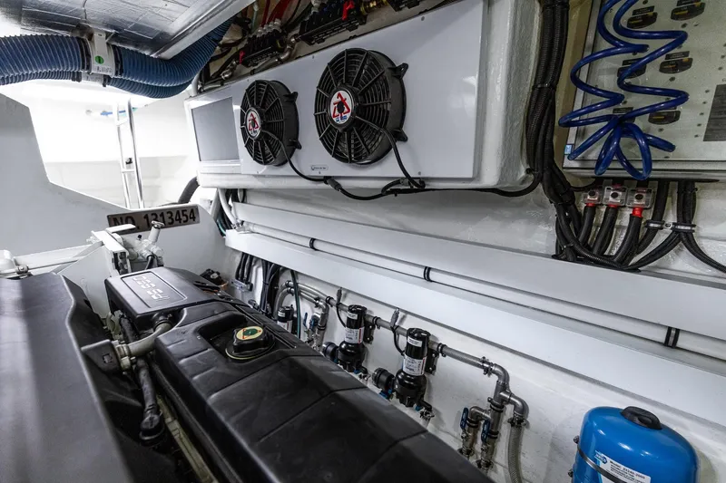 Frivolous Yacht Photos Pics Engine room of 2021 Riviera 5400 Sport Yacht Platinum Edition, showcasing mechanical components.