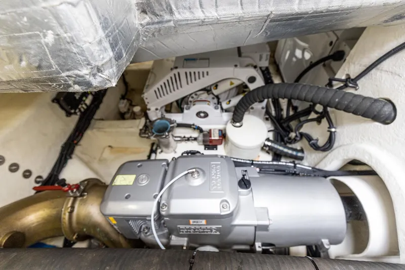 Frivolous Yacht Photos Pics Engine room of 2021 Riviera 5400 Sport Yacht Platinum Edition, showcasing mechanical components.