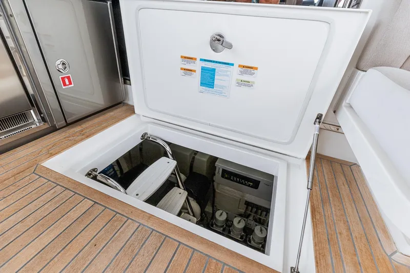 Frivolous Yacht Photos Pics 2021 Riviera 5400 Sport Yacht engine compartment with open hatch and visible equipment.