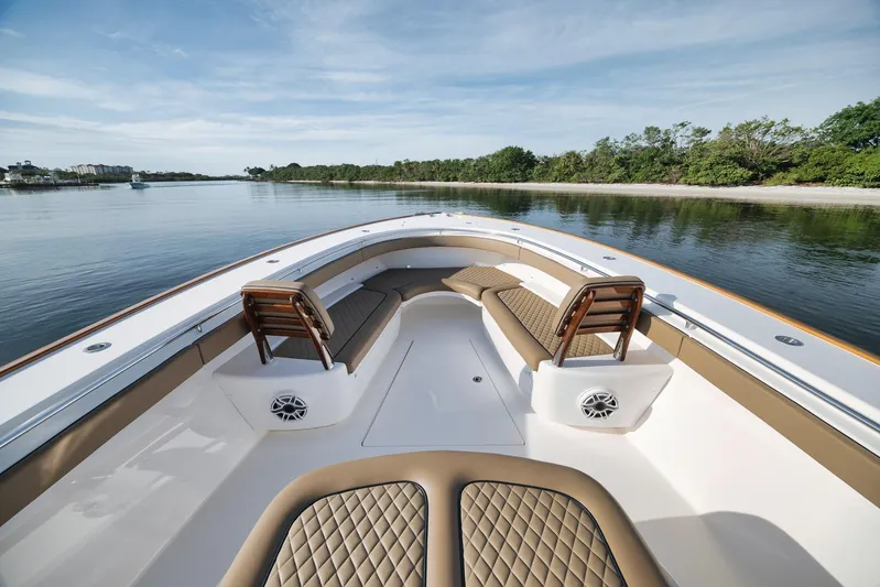  Yacht Photos Pics 2022 Valhalla Boatworks V-41 luxury boat interior with cushioned seating and scenic water view.