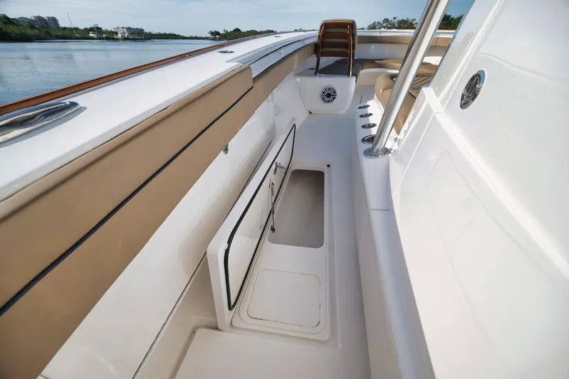  Yacht Photos Pics 2022 Valhalla Boatworks V-41 interior with open storage compartment, sleek design, and comfortable seating.