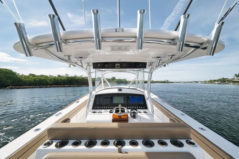  Yacht Photos Pics 2022 Valhalla Boatworks V-41 helm with advanced navigation, rod holders, and scenic waterway view.