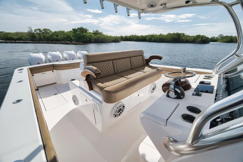  Yacht Photos Pics 2022 Valhalla Boatworks V-41 interior with luxurious seating and modern controls on a serene waterway.