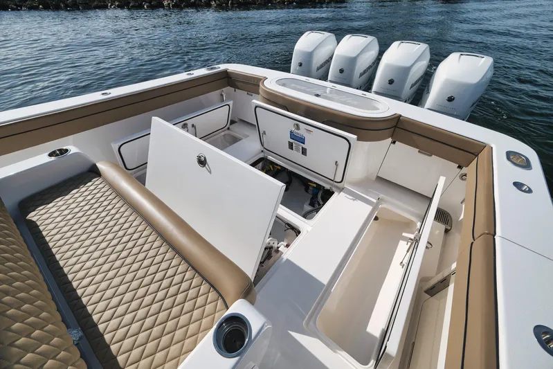  Yacht Photos Pics 2022 Valhalla Boatworks V-41 interior with open storage compartments and quad Mercury engines.