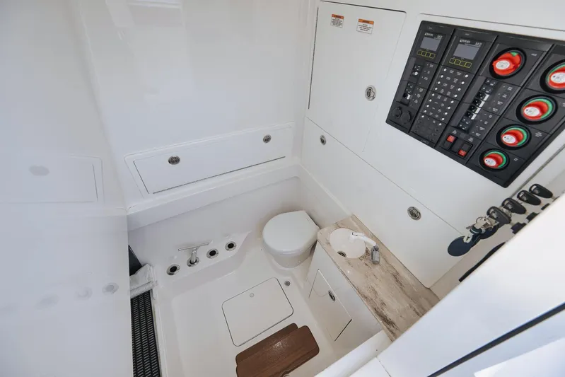  Yacht Photos Pics 2022 Valhalla Boatworks V-41 interior with control panel and compact bathroom amenities.