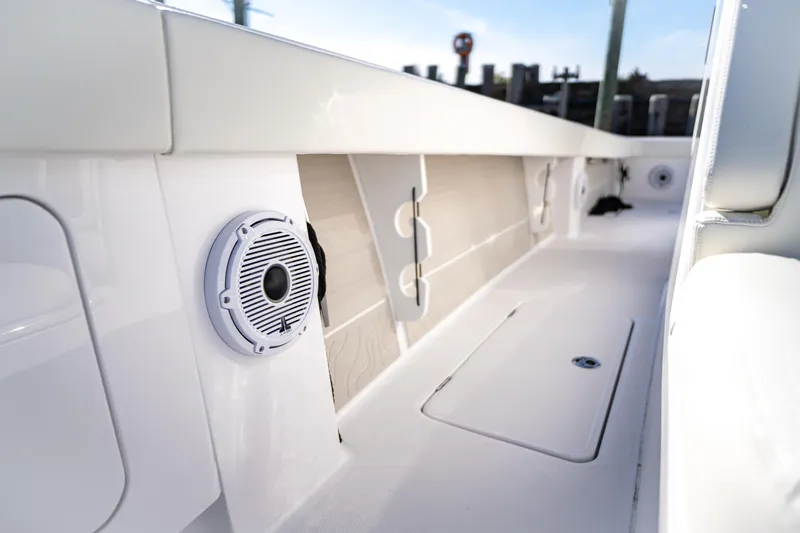 In Stock Yacht Photos Pics Interior view of a 2026 Jupiter 32 boat, featuring sleek white design and built-in speaker.