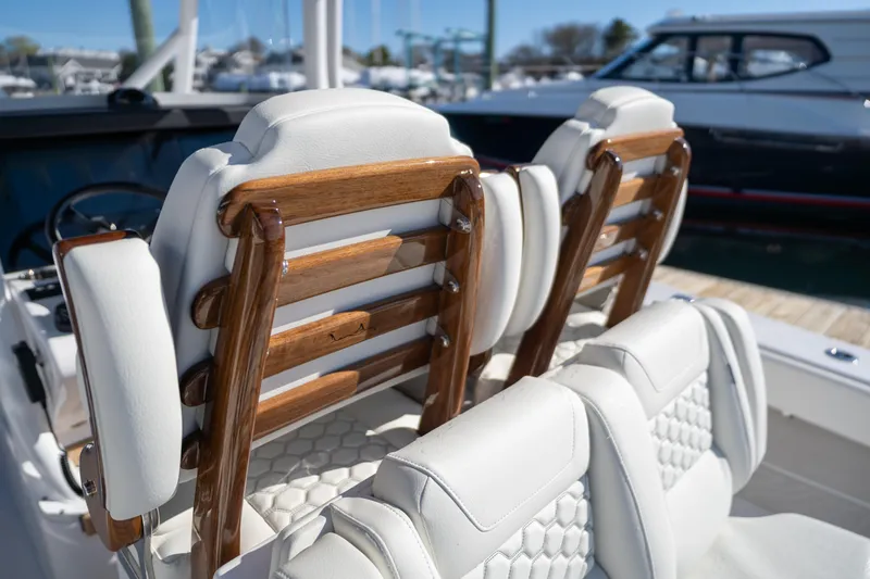 In Stock Yacht Photos Pics Luxury seating on a 2026 Jupiter 32 boat with elegant wood accents.
