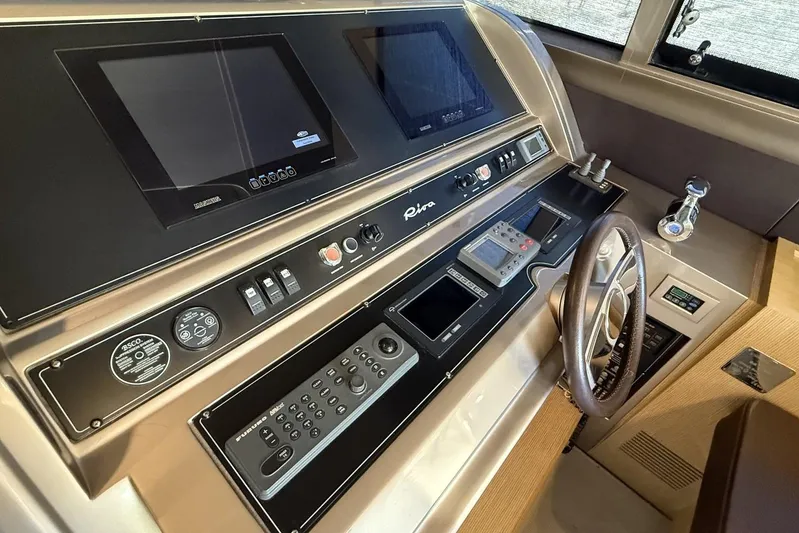 "alin 4ever" Yacht Photos Pics Control panel of 2010 Riva 68 Ego Super yacht with steering wheel and navigation screens.